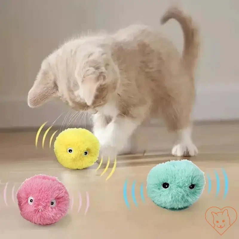 A playful kitten interacting with colorful plush catnip balls that emit sounds.