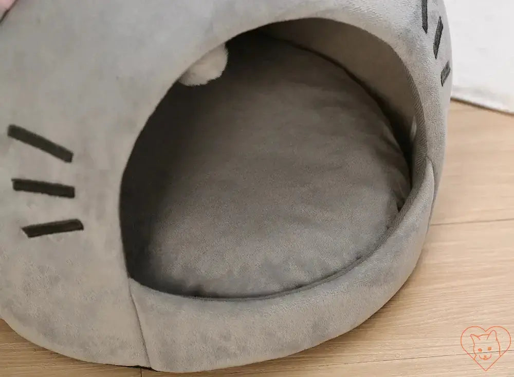 Cozy gray semi-enclosed cat bed with soft reversible cushion and hanging toy for ultimate feline comfort.