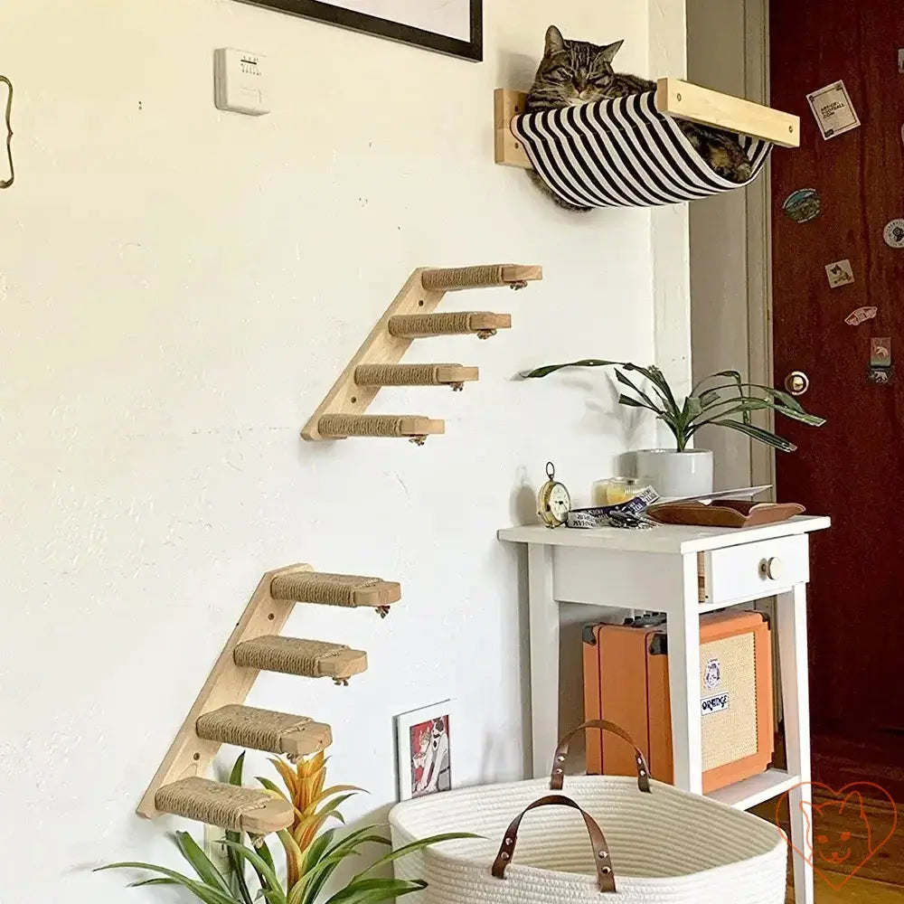 Wall-mounted cat climbing shelf with four steps and a sisal scratching post, featuring a cat lounging in a striped hammock.