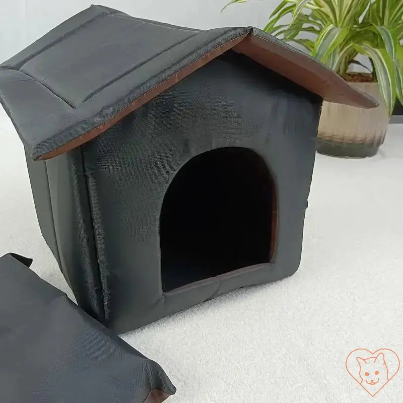 Waterproof outdoor cat house with insulated design, perfect portable shelter for pets in any weather.