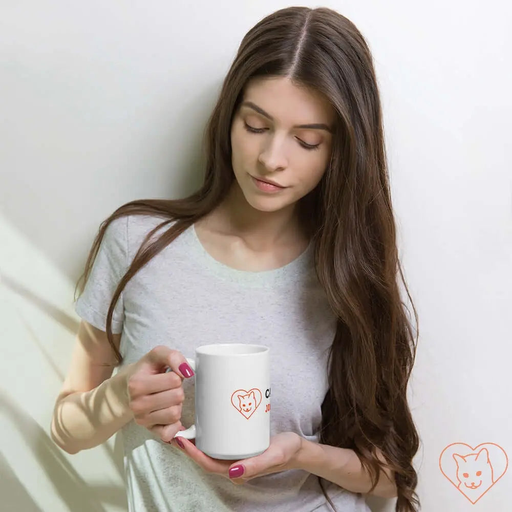 Model holding a white glossy mug with Cat World logo, perfect for coffee or tea lovers.