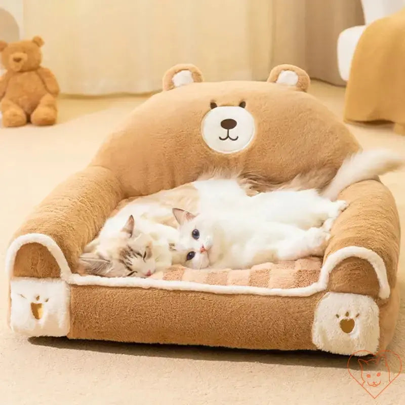 Two cats lounging in a winter plush cat bed designed like a bear, creating a cozy and soft sleeping environment.