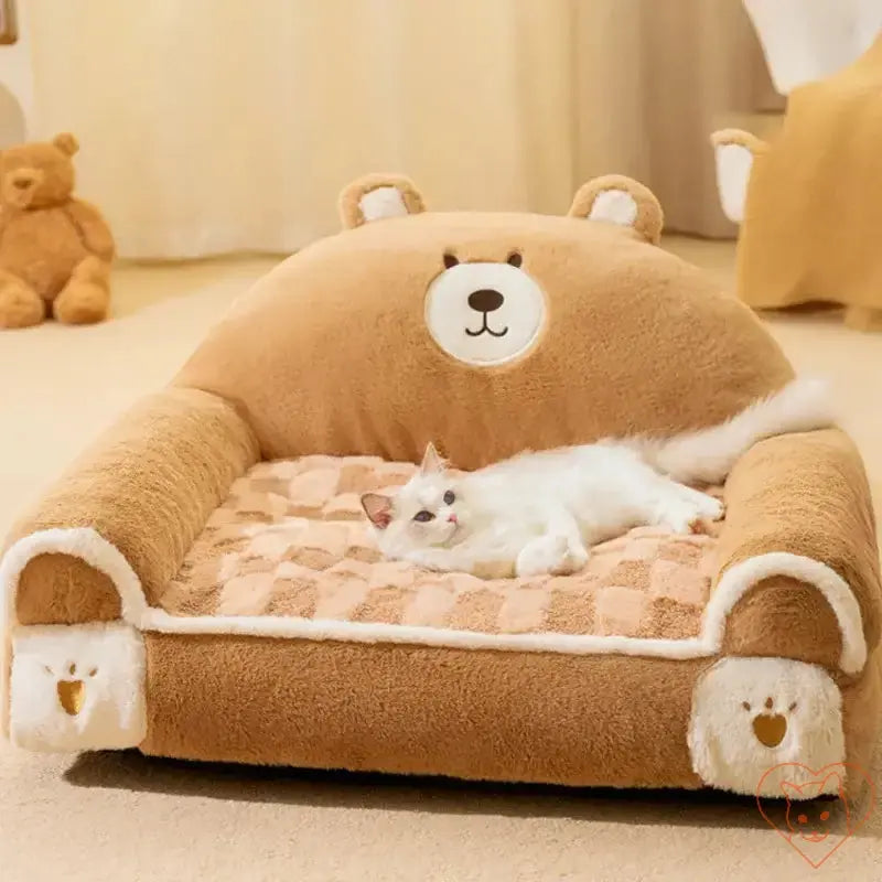 Cozy winter plush cat bed shaped like a bear, featuring a white cat lounging comfortably on its soft surface.