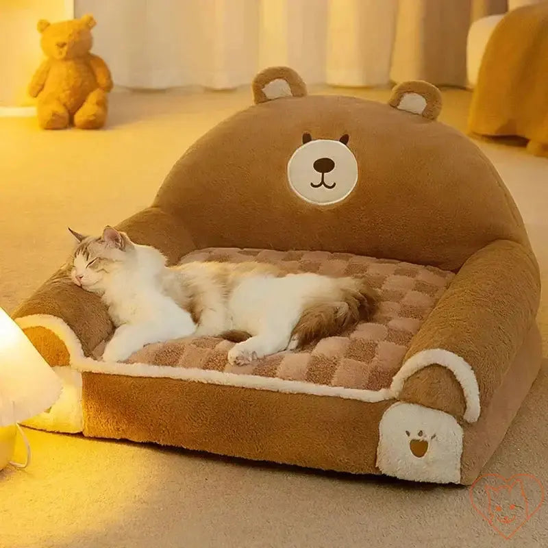 Cozy Winter Plush Cat Bed in bear shape with a sleepy cat, providing warmth and comfort for pets.